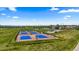 Aerial view of outdoor pickleball courts within a residential community, surrounded by green spaces at 265 Calhoun Cir, Castle Rock, CO 80104