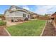 Spacious backyard features lush green lawn, patio areas, and a lovely space for outdoor activities at 484 N Jamestown Way, Aurora, CO 80018