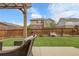 A spacious backyard features a grassy lawn, wood fence and a covered patio with outdoor seating at 484 N Jamestown Way, Aurora, CO 80018