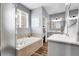 Bright bathroom featuring soaking tub, natural light, and double sink vanity at 484 N Jamestown Way, Aurora, CO 80018
