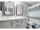 Spacious bathroom with double sinks, white cabinets, and a shower featuring a decorative curtain at 484 N Jamestown Way, Aurora, CO 80018