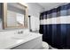 Bathroom featuring modern vanity with a white countertop and a shower with a stylish, striped curtain at 484 N Jamestown Way, Aurora, CO 80018