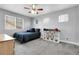 Neutral toned bedroom with carpet, a ceiling fan, and natural light from three windows at 484 N Jamestown Way, Aurora, CO 80018