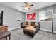 Cozy bedroom featuring a comfortable sectional couch, ceiling fan, and ample natural light at 484 N Jamestown Way, Aurora, CO 80018