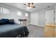Bedroom with three windows, ceiling fan, and modern decor with a sliding closet door at 484 N Jamestown Way, Aurora, CO 80018