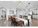 Elegant dining room features a modern chandelier and seamless connection to the kitchen area at 484 N Jamestown Way, Aurora, CO 80018