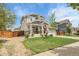 Charming two-story home featuring a landscaped yard, inviting front porch, and a well-maintained lawn at 484 N Jamestown Way, Aurora, CO 80018