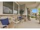 Cozy front porch offers seating, stone accents, and relaxing view of the surrounding landscape at 484 N Jamestown Way, Aurora, CO 80018