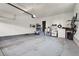 An empty garage with storage shelves, bike rack, and an open space for parking vehicles at 484 N Jamestown Way, Aurora, CO 80018