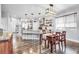 Open-concept kitchen and dining area with stylish lighting and modern finishes, perfect for entertaining at 484 N Jamestown Way, Aurora, CO 80018