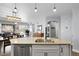 Open kitchen features a central island with sink and seating and views into the living spaces at 484 N Jamestown Way, Aurora, CO 80018
