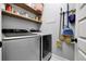 Well-organized laundry room with modern washer and dryer and storage shelves at 484 N Jamestown Way, Aurora, CO 80018