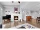 Bright living room with fireplace, wood floors, and open layout to dining area at 484 N Jamestown Way, Aurora, CO 80018