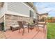 Relaxing outdoor patio with brick flooring features a dining table, chairs, and a beautiful backyard at 484 N Jamestown Way, Aurora, CO 80018