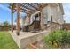 Covered patio with wood pergola and comfortable outdoor seating provides a relaxing outdoor living space at 484 N Jamestown Way, Aurora, CO 80018