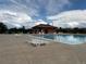 Community pool with lounge chairs offers a refreshing space for relaxation and recreation under blue skies at 484 N Jamestown Way, Aurora, CO 80018