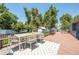 Relaxing backyard deck featuring an outdoor dining set, lush greenery, and a tranquil ambiance at 995 Chase St, Lakewood, CO 80214