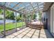 Covered patio leading to a backyard deck with outdoor dining set, overlooking a grassy yard at 995 Chase St, Lakewood, CO 80214