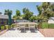 Relaxing backyard deck featuring an outdoor dining set, lush greenery, and a tranquil ambiance at 995 Chase St, Lakewood, CO 80214