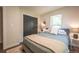 Bright bedroom featuring a comfortable bed, sliding closet doors, and a window with natural light at 995 Chase St, Lakewood, CO 80214