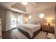 Sunlit bedroom with tray ceiling, a sliding glass door and cozy decor at 995 Chase St, Lakewood, CO 80214