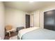 Cozy bedroom with a chair, storage trunk and a view of the hallway at 995 Chase St, Lakewood, CO 80214