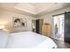 Spacious bedroom featuring tray ceilings, natural light, and an attached bath at 995 Chase St, Lakewood, CO 80214