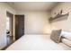 Bright bedroom featuring a comfy bed, stylish decor, and a view into another room at 995 Chase St, Lakewood, CO 80214
