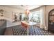 Bright dining room with a patterned rug, modern table, and a view of the backyard at 995 Chase St, Lakewood, CO 80214