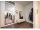 Stylish entryway with a white bench, coat rack, and view into a modern kitchen and living area at 995 Chase St, Lakewood, CO 80214