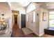 Inviting foyer boasts a hardwood floor, arched window above the front door, and a view of the hallway at 995 Chase St, Lakewood, CO 80214