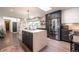 Spacious kitchen features an island with seating, modern appliances, and black and white cabinetry at 995 Chase St, Lakewood, CO 80214