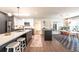 Open concept kitchen with island, pendant lighting, and seamless flow to the dining area at 995 Chase St, Lakewood, CO 80214