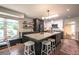 Well-lit kitchen features black and white cabinets, a large island, and hardwood flooring at 995 Chase St, Lakewood, CO 80214