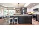 Bright kitchen boasts an island with seating, modern appliances, a skylight, and stylish lighting at 995 Chase St, Lakewood, CO 80214