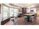 Modern kitchen features black and white cabinetry, an island with seating, and a dining nook at 995 Chase St, Lakewood, CO 80214