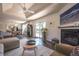 Bright living room featuring hardwood floors, fireplace, tray ceiling, and access to outdoor space at 995 Chase St, Lakewood, CO 80214