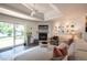 Bright living room with a fireplace, modern decor, and access to the backyard patio at 995 Chase St, Lakewood, CO 80214