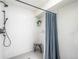 Bright shower with a handheld shower head, white subway tile, and sleek hardware at 995 Chase St, Lakewood, CO 80214