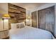 Charming bedroom with wood accent wall and cozy decor, featuring a plush bed and ample closet space at 820 Columbine Rd # 10, Breckenridge, CO 80424
