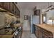 Kitchen with wooden cabinets and stainless steel appliances and fixtures at 820 Columbine Rd # 10, Breckenridge, CO 80424