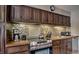Close up of the kitchen featuring wooden cabinets, tile backsplash, and appliances at 820 Columbine Rd # 10, Breckenridge, CO 80424