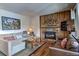 Comfortable living room with a stone fireplace, hardwood floors, and a balcony view at 820 Columbine Rd # 10, Breckenridge, CO 80424
