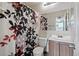 Compact bathroom features a decorative shower curtain, toilet, vanity, and mirror, creating a functional space at 2291 S Jasper Way # B, Aurora, CO 80013