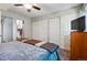 This bright carpeted bedroom features a ceiling fan, and a set of mirrored closets at 2291 S Jasper Way # B, Aurora, CO 80013