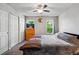 This bedroom features carpeted floors, a ceiling fan, a double closet, and dual windows to let in natural light at 2291 S Jasper Way # B, Aurora, CO 80013