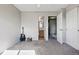 Carpeted bedroom with neutral walls, a guitar, access to a bathroom and staircase, creating a cozy atmosphere at 2291 S Jasper Way # B, Aurora, CO 80013