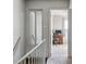 Second floor hallway with an open doorway to a bedroom with a desk and chair, providing access to rooms at 2291 S Jasper Way # B, Aurora, CO 80013