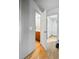 Hallway leading to a bathroom with a tiled floor and wooden vanity, showcasing the home's interior design at 2291 S Jasper Way # B, Aurora, CO 80013