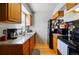 Functional kitchen showcasing wood cabinets, granite countertops, and essential appliances for meal preparation at 2291 S Jasper Way # B, Aurora, CO 80013